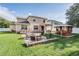 Large fenced in backyard featuring a fire pit, outdoor kitchen, and a covered patio at 1524 Rhodeswell Ln, Dover, FL 33527