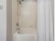Clean bathroom featuring tub-shower combination with tiled walls and shower curtain at 1524 Rhodeswell Ln, Dover, FL 33527