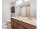 Bathroom with double vanity sinks, large mirror, and a shower-tub combination at 1524 Rhodeswell Ln, Dover, FL 33527