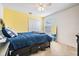 Bright bedroom featuring a blue bedspread, closet, ceiling fan, and natural light at 1524 Rhodeswell Ln, Dover, FL 33527