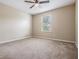 Bright bedroom with a ceiling fan and window, carpeted floors and neutral colored walls at 1524 Rhodeswell Ln, Dover, FL 33527