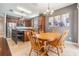 Open-concept dining area next to a kitchen island with bar seating, pendant lighting and neutral decor at 1524 Rhodeswell Ln, Dover, FL 33527