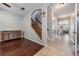 Inviting foyer with hardwood and tile floors, staircase, and an arched doorway at 1524 Rhodeswell Ln, Dover, FL 33527