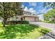 Charming two-story home with a three car garage, stone accents, and a tree in the front lawn at 1524 Rhodeswell Ln, Dover, FL 33527