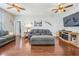 A beautifully staged living room featuring hardwood floors, ceiling fans, and comfortable seating at 1524 Rhodeswell Ln, Dover, FL 33527
