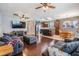Open living room showcasing hardwood flooring, access to the kitchen and dining areas, plus comfortable seating at 1524 Rhodeswell Ln, Dover, FL 33527