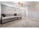 Upstairs loft area featuring neutral carpet, large sectional sofa, and natural lighting at 1524 Rhodeswell Ln, Dover, FL 33527