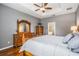 Main bedroom features a tray ceiling with fan and an en-suite bath with a soaking tub and walk-in shower at 1524 Rhodeswell Ln, Dover, FL 33527