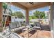 Covered patio area with comfortable seating, outdoor kitchen and a view of the fenced backyard at 1524 Rhodeswell Ln, Dover, FL 33527