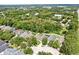 A high angle of a property showcasing a fenced backyard with dense foliage and a community neighborhood at 16928 Hawkridge Rd, Lithia, FL 33547