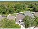 High angle of a home with a manicured lawn and a fenced backyard amid a leafy residential area at 16928 Hawkridge Rd, Lithia, FL 33547