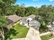 Aerial view captures a home's lush lawn, two-car garage, and proximity to neighborhood greenery at 16928 Hawkridge Rd, Lithia, FL 33547