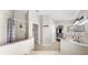 Bright bathroom featuring a double vanity, tiled shower, and tiled flooring at 16928 Hawkridge Rd, Lithia, FL 33547