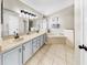 A luxurious main bathroom with dual vanity, soaking tub, and modern fixtures at 16928 Hawkridge Rd, Lithia, FL 33547