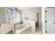 Well-lit bathroom featuring a soaking tub, separate shower, and stylish decor at 16928 Hawkridge Rd, Lithia, FL 33547