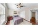 Cozy bedroom with a ceiling fan, dark wood floors, and a neutral color palette at 16928 Hawkridge Rd, Lithia, FL 33547