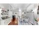 Open-concept dining room with hardwood floors, a piano and bright lighting at 16928 Hawkridge Rd, Lithia, FL 33547