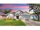 Charming single-story home features a well-manicured lawn, two-car garage, and delightful curb appeal at 16928 Hawkridge Rd, Lithia, FL 33547