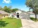 A single-story home offers a well-maintained lawn, American flag, and a convenient two-car garage at 16928 Hawkridge Rd, Lithia, FL 33547