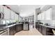 Bright kitchen boasts black granite counters, stainless appliances, and white and dark wood cabinetry at 16928 Hawkridge Rd, Lithia, FL 33547