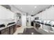Kitchen showcases stainless appliances, granite counters, white cabinetry, and a tiled floor at 16928 Hawkridge Rd, Lithia, FL 33547
