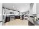 Charming kitchen features stainless steel appliances, granite counters, and light, neutral tile flooring at 16928 Hawkridge Rd, Lithia, FL 33547