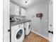 Laundry room with white washer, dryer, cabinets, counter, and wood-look floor at 16928 Hawkridge Rd, Lithia, FL 33547