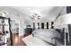 A main bedroom with a large bed, modern furniture, and an ensuite bathroom at 16928 Hawkridge Rd, Lithia, FL 33547