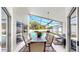 Covered patio with outdoor dining and seating with view of pool and backyard at 16928 Hawkridge Rd, Lithia, FL 33547