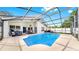 Backyard pool and patio with seating, dining, and lush landscaping create a backyard oasis at 16928 Hawkridge Rd, Lithia, FL 33547