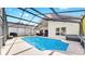 Backyard pool, patio with dining and seating, and lush landscaping create a backyard oasis at 16928 Hawkridge Rd, Lithia, FL 33547
