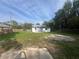 Spacious backyard with green grass and partial fencing, offering plenty of room for outdoor activities at 18127 Us Highway 41, Spring Hill, FL 34610