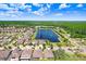 Breathtaking aerial view of the property, revealing its beautiful community, lakes, manicured lawns, and proximity to various amenities at 18824 Birchwood Groves Dr, Lutz, FL 33558