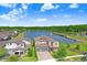 Scenic aerial view of home with a beautiful lake, fountain, and manicured landscaping at 18824 Birchwood Groves Dr, Lutz, FL 33558
