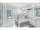 Bright, marble-clad primary bathroom featuring soaking tub, shower and dual vanity at 18824 Birchwood Groves Dr, Lutz, FL 33558