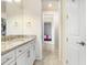 Bathroom featuring a vanity with granite countertops and a doorway leading to other areas at 18824 Birchwood Groves Dr, Lutz, FL 33558