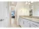 Bathroom featuring a vanity with granite countertops and a doorway leading to other areas at 18824 Birchwood Groves Dr, Lutz, FL 33558