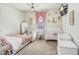 Charming Bedroom with a crib, rocker, and soft pink accents creating a cozy atmosphere at 18824 Birchwood Groves Dr, Lutz, FL 33558