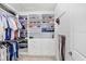 Organized walk-in closet featuring built-in shelving and drawers for efficient storage at 18824 Birchwood Groves Dr, Lutz, FL 33558