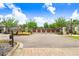 Secured community entrance gate featuring decorative metal panels and professionally maintained landscaping at 18824 Birchwood Groves Dr, Lutz, FL 33558