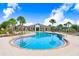 Inviting community pool with ample seating, palm trees, and clear blue water for relaxation and recreation at 18824 Birchwood Groves Dr, Lutz, FL 33558