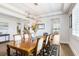 Dining room with an eight place table and chairs and a modern chandelier at 18824 Birchwood Groves Dr, Lutz, FL 33558