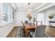 Formal dining room boasts natural light, modern chandelier, and seating for six at 18824 Birchwood Groves Dr, Lutz, FL 33558