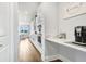 Bright kitchen features white cabinets, stainless steel appliances, and a granite countertop at 18824 Birchwood Groves Dr, Lutz, FL 33558