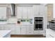 Bright kitchen features white cabinets, stainless steel appliances, and a window over the sink at 18824 Birchwood Groves Dr, Lutz, FL 33558
