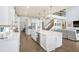 Open-concept kitchen with white cabinets, a large island, and a view of the living area at 18824 Birchwood Groves Dr, Lutz, FL 33558