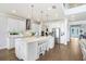 Stylish kitchen with white cabinets, stainless steel appliances, and a large center island at 18824 Birchwood Groves Dr, Lutz, FL 33558