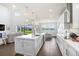Spacious kitchen featuring a large island with sleek white cabinets and pendant lighting at 18824 Birchwood Groves Dr, Lutz, FL 33558