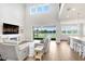 Open living room boasts high ceilings, waterfront views, and seamless access to the kitchen at 18824 Birchwood Groves Dr, Lutz, FL 33558