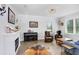 Bright living room with modern fireplace, piano, and lots of natural light at 18824 Birchwood Groves Dr, Lutz, FL 33558
